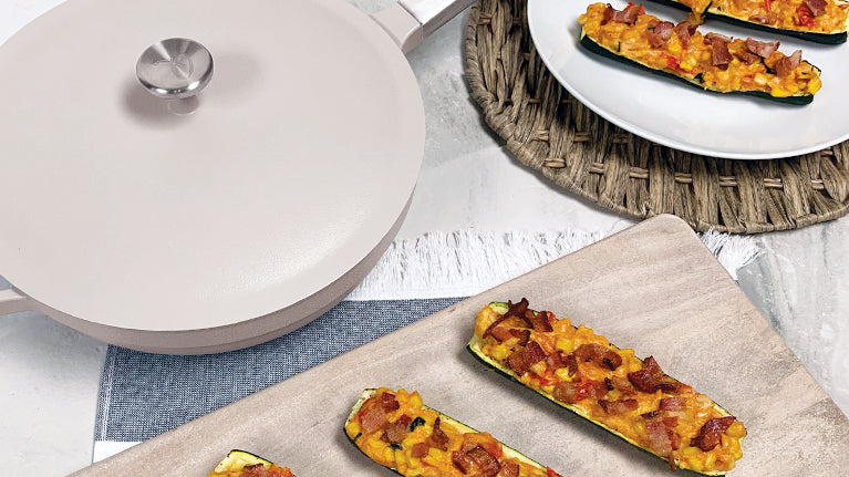 Chicken Chowder Stuffed Zucchini on a plate and serving board with the gray pan