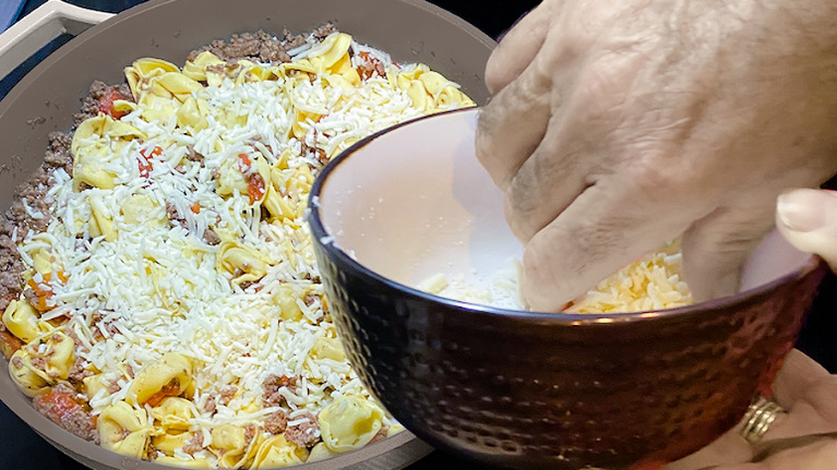 Easy Cheesy Tortellini inside of The Pan with parmesan cheese sprinkled on top