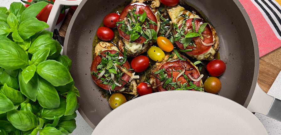 Chicken Caprese with tomatoes and seasoning in The Pan by Perco with green leaves