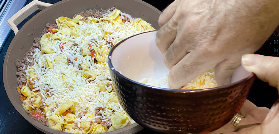 Easy Cheesy Tortellini inside of The Pan with parmesan cheese sprinkled on top