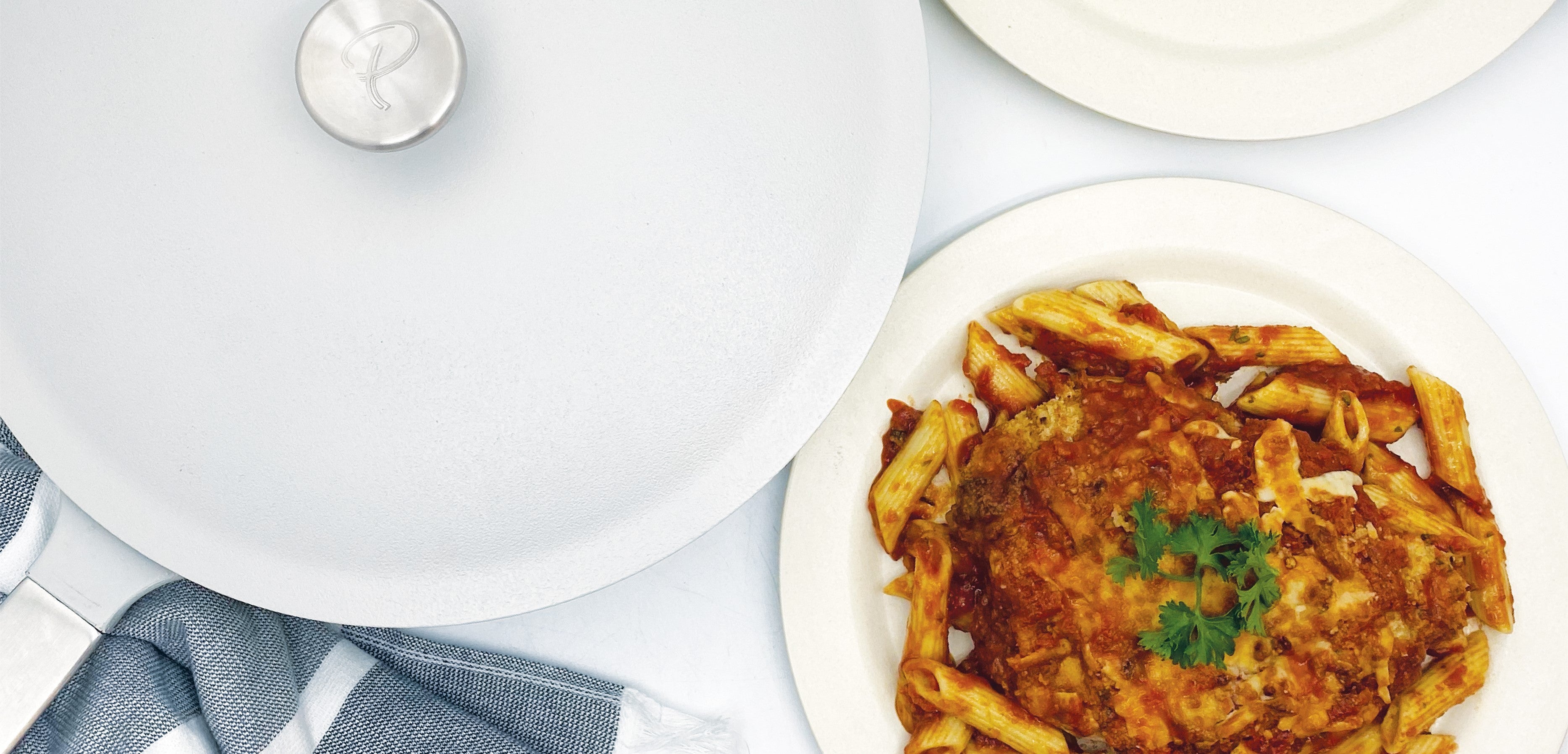 One-Pan Chicken Parm Pasta Recipe on a plate beside The Pan