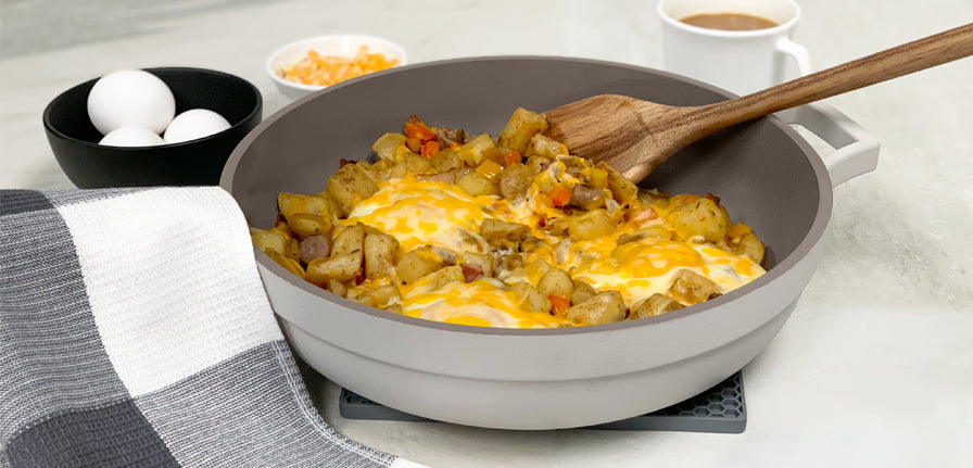 Savoury One-pan Breakfast Skillet Recipe inside of The Gray Pan with The Spoon surrounded by Coffee and eggs