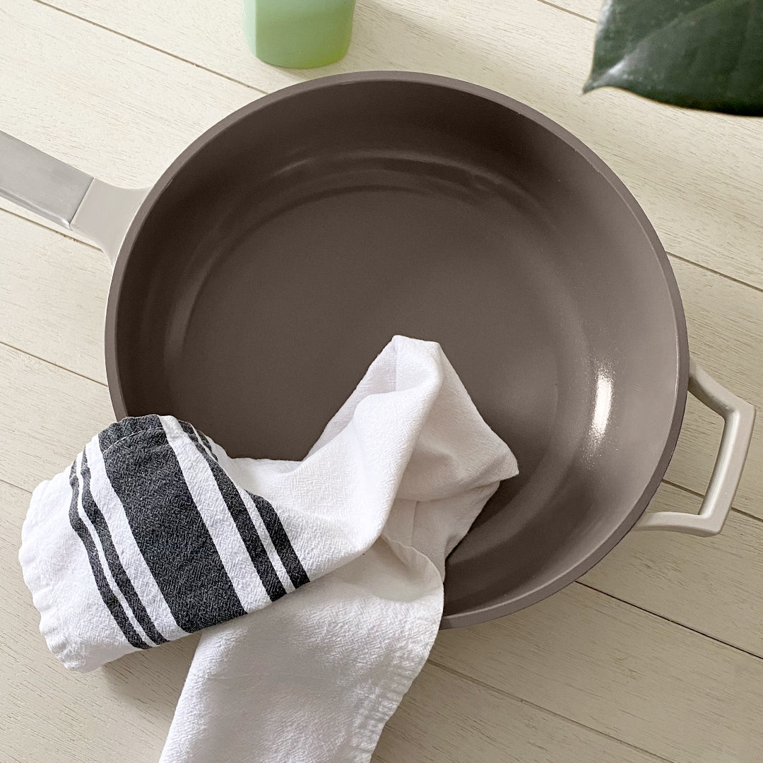 The Pan in Warm Gray with a towel on a wooden table